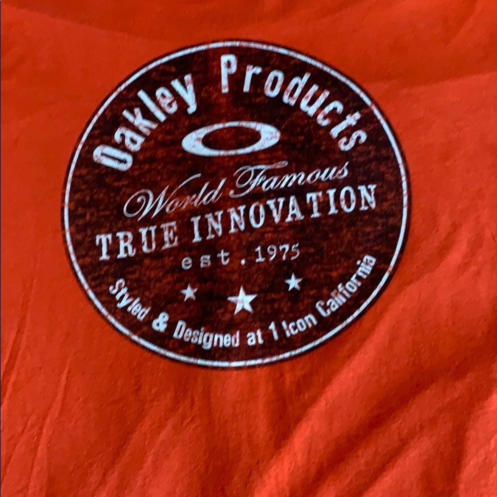 Brand new Oakley Shirt! Orange, No stains.